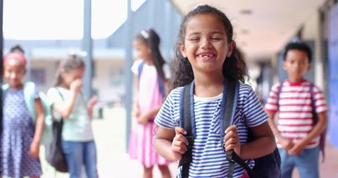 Joyful Schoolgirl With Backpack Smiling in Hallway with Friends - Download Free Stock Images Pikwizard.com