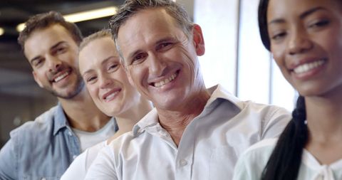Diverse group of adults smiling together, celebrating success