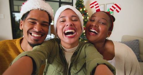 Friends Taking Joyful Selfie in Festive Holiday Setting