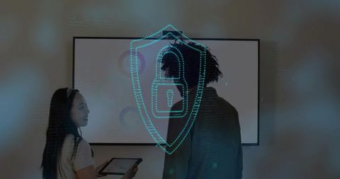 Business team collaborating in boardroom presenting holographic cybersecurity shield