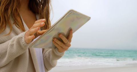 Woman Using Tablet on Tranquil Beach - Download Free Stock Images Pikwizard.com