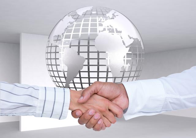Business executives shaking hands, symbolizing international partnerships and collaborations. Perfect for business presentations, global cooperation themes, and corporate websites demonstrating successful business meetings and agreements.