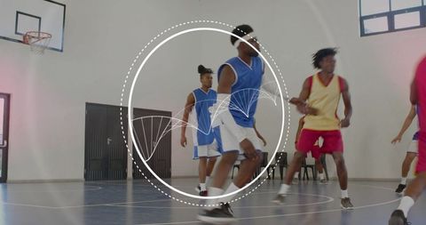 Competitive indoor basketball team playing and defending with dynamic motion overlay