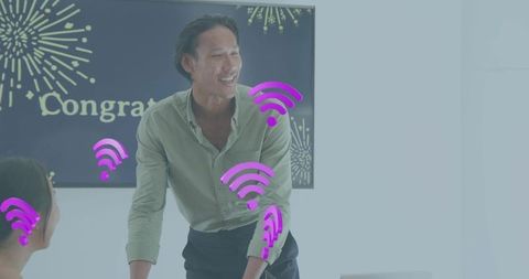 Smiling team leader celebrating success during meeting with wi-fi icons and fireworks