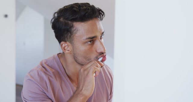 Young Man Brushing Teeth in Bathroom with Focused Expression - Download Free Stock Images Pikwizard.com