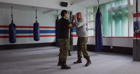 Army Instructor Demonstrating Self-Defense Techniques in Training Gym