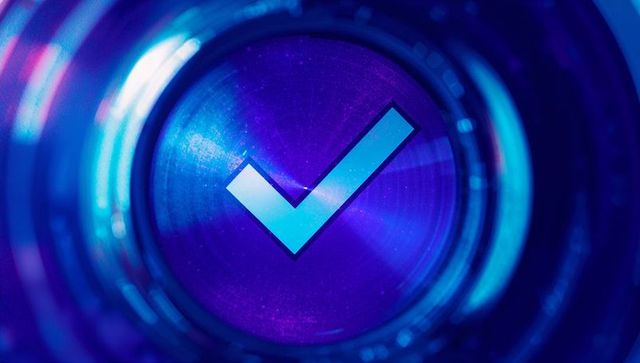 Glowing blue check mark in abstract digital graphic design