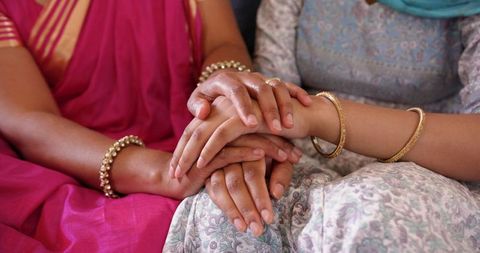 Indian Mother and Daughter Holding Hands Showing Unity