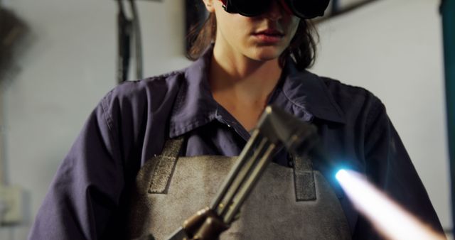 Woman Welding with Protective Gear in Industrial Workshop - Download Free Stock Images Pikwizard.com