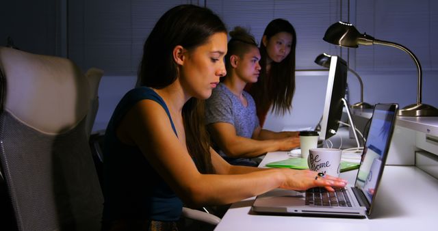 Young Professionals Working Late at Modern Office - Download Free Stock Images Pikwizard.com