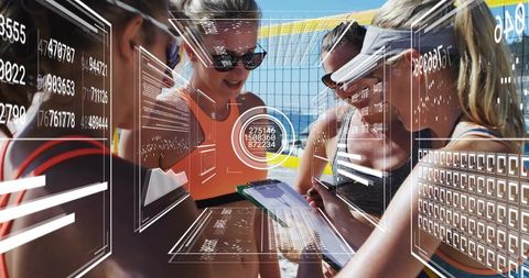 Female beach volleyball team planning strategy with hud data overlay and coaching