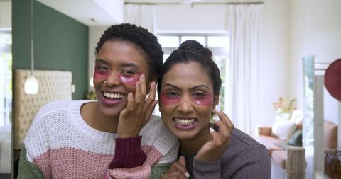 Diverse friends enjoying skincare ritual with eye gel patches