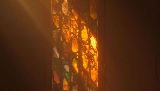 Warm Light through Stained Glass and Metal Grille