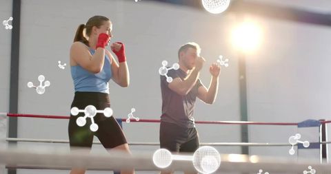 Boxing sparring partners training in ring with hand wraps and futuristic molecule graphics