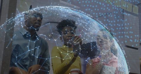 Diverse Professionals Analyzing Digital Globe Projection in Office