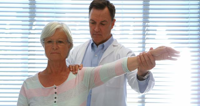 Doctor Examining Elderly Patient's Arm Mobility - Download Free Stock Images Pikwizard.com