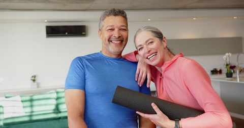 Senior couple embracing healthy lifestyle with yoga at home