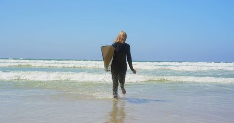 Senior Woman Running Towards Surfing Adventure in Ocean - Download Free Stock Images Pikwizard.com