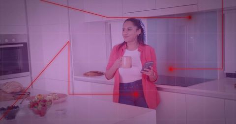 Woman Drinking Coffee and Using Smartphone in Modern Kitchen