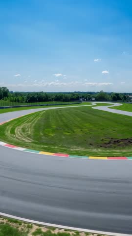 Vertical Drone Panning Over Curving Race Track Kerbs at Rural Motorsport Circuit