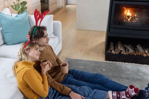 Cozy Couple Enjoying Warmth of Fireplace During Festive Season