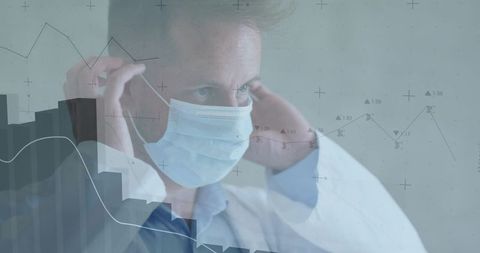 Physician Adjusting Surgical Mask While Monitoring Healthcare Data Analytics