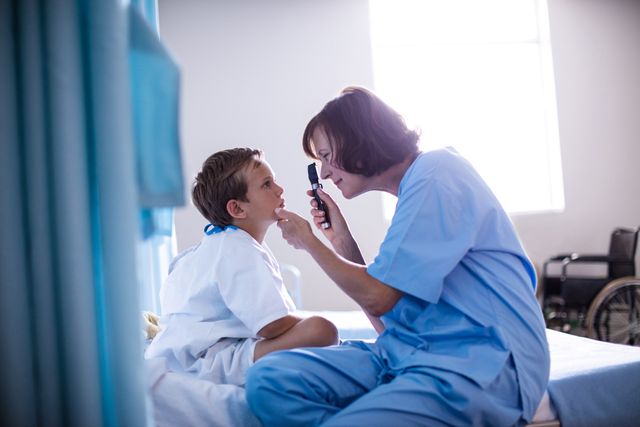 This image depicts a female doctor examining a young child's eye using an ophthalmic device in a hospital. The scene highlights the importance of pediatric care and medical checkups. It can be used in healthcare-related articles, medical websites, pediatric care promotions, and educational materials about eye health and medical examinations.