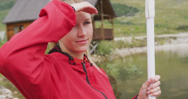 Woman Wearing Red Jacket Holding Pole Near Lake - Download Free Stock Images Pikwizard.com