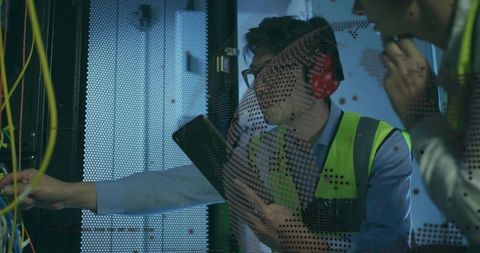 Technicians conducting maintenance in data center server room