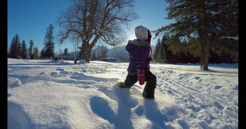 Child Playing in Snow-Covered Landscape on Sunny Winter Day - Download Free Stock Images Pikwizard.com
