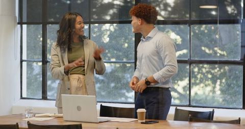 Diverse Business Professionals Celebrating Success in Modern Office