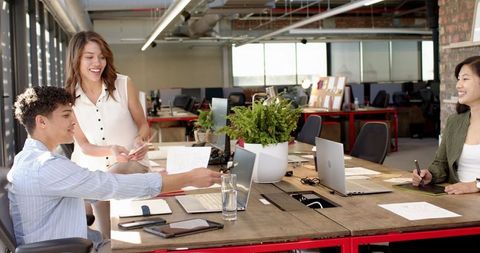 Diverse Coworkers Collaborating in Modern Loft Office Setting