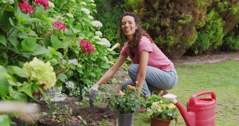 Joyful Woman Planting Flowers in Lush Garden Setting