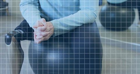 Woman balancing on exercise ball in gym enhancing fitness and wellness