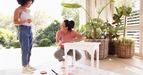 Mother and Daughter Enjoying Coffee and Bonding Outdoors