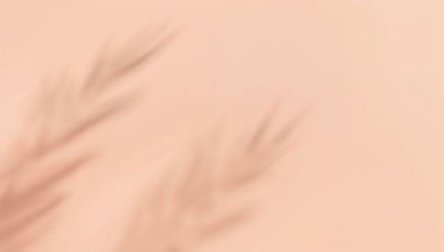 Casting Soft Palm-Frond Shadows on Peach-Beige Surface Minimalist Botanical Background
