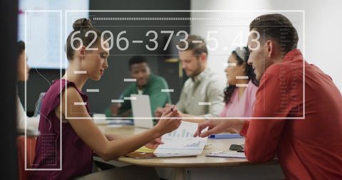 Business Team Analyzing Reports During Strategic Meeting