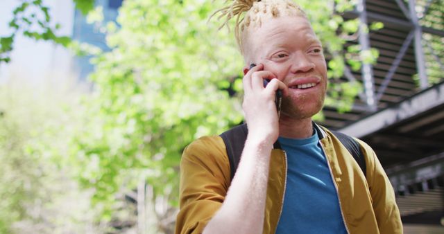 Albino Man Talking on Smartphone in Outdoor Urban Setting - Download Free Stock Images Pikwizard.com