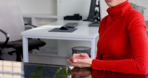 Businesswoman in Red Sweater Gesturing at Office Desk - Download Free Stock Images Pikwizard.com