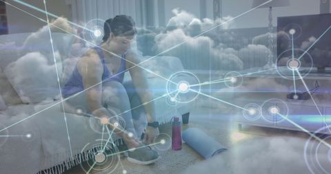 Woman tying sneakers with network overlay for fitness concept