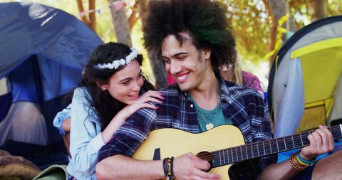 Young Friends Enjoying Music at Outdoor Festival Camp