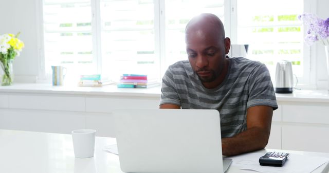 Man Working from Home on Laptop in Bright Kitchen - Download Free Stock Images Pikwizard.com