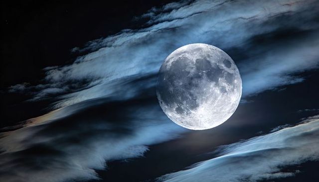 Full Moon Rising Through Haloed Clouds, Detailed Lunar Surface with Craters and Maria