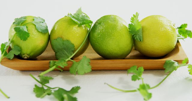 Limes with Fresh Cilantro on Wooden Tray - Download Free Stock Images Pikwizard.com