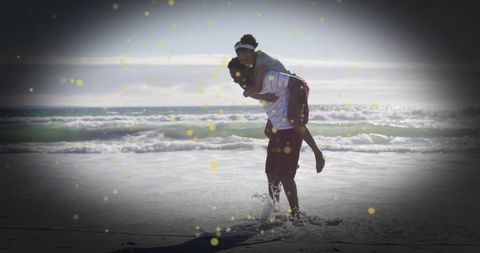 Joyful couple enjoying beach adventure at sunset