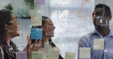 Diverse Team Collaborating on Creative Strategy Using Glass Wall
