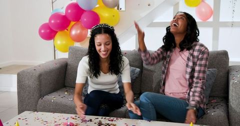 Joyful Celebration with Balloons and Confetti Among Friends