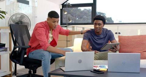 Creative teamwork at home office with digital devices and color swatches