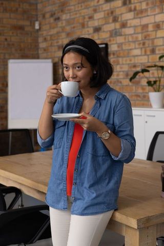 Businesswoman Enjoying Coffee Break in Corporate Workspace