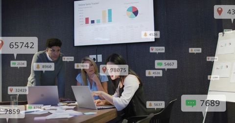 Multicultural team analyzing sales dashboard with interactive metrics in modern boardroom